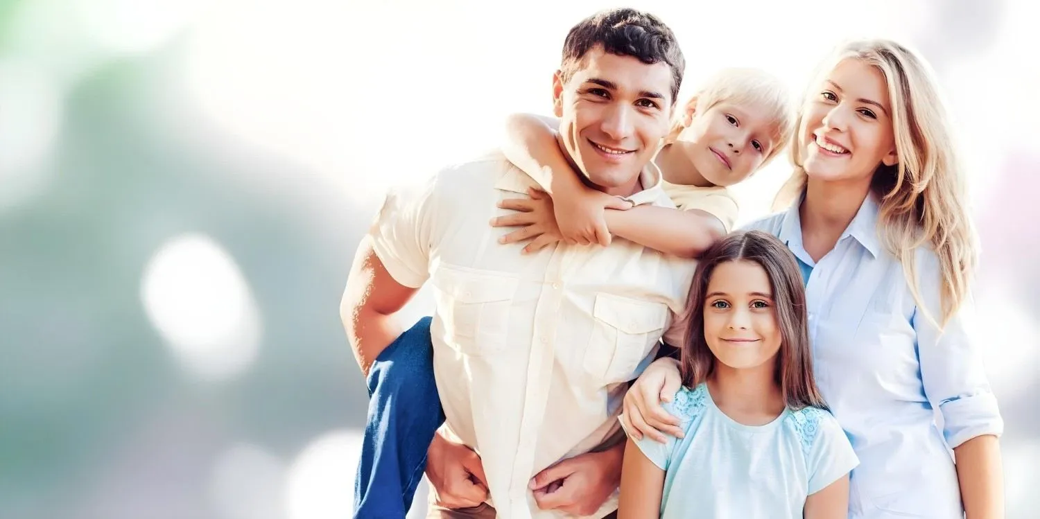 A family of four standing together